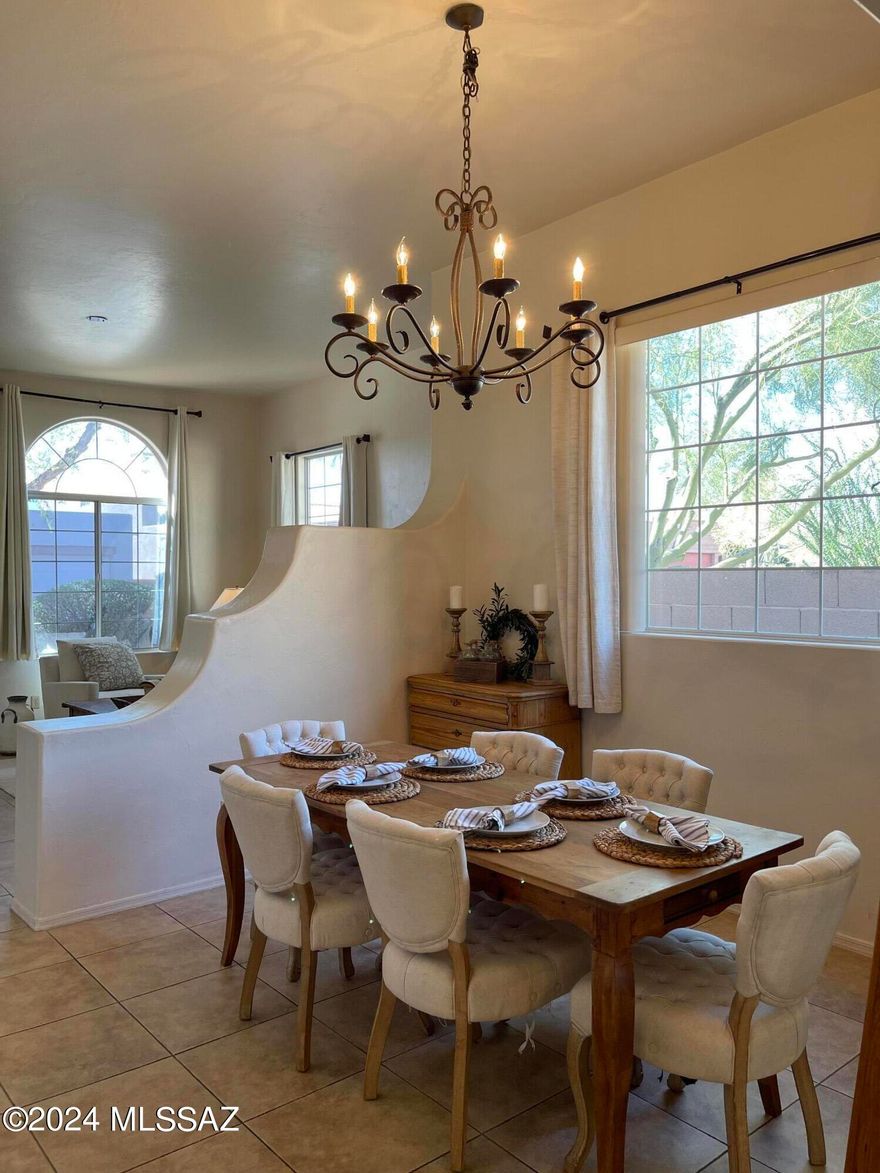 Nestled in the charming gated community of Sierra Catalina Estates in the Foothills, this home offers lovely mountain views. High ceilings and a thoughtful floorplan make this home feel spacious and serene. The kitchen has abundant storage, a peninsula for entertaining, and opens to a sitting room with fireplace and doors to covered patio. Enjoy the generously sized primary suite with large bathroom featuring separate toilet, dual vanity, and walk-in closet. Neutral tile throughout. Two additional bedrooms, hall bathroom with tub, and laundry/mud room which leads to the two-car garage. HOA amenities include pool, spa, front yard landscaping and trash pick-up. Ideally located for shopping and dining at La Encantada center and nearby restaurants & galleries.  Short drive to University & downtown Tucson.  Don't miss this Gem!