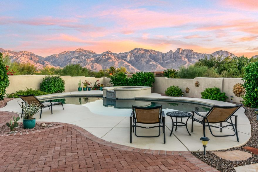 Sunrise to Sunset dramatic Catalina Mountain  views abound from this impeccably maintained Sante Fe style home. Located on one of the finest elevated homesites in gated Estates at High Mesa this hill top retreat takes inspiration from light pouring through walls of windows and commanding views. A perfect blend of casual and formal  spaces the floor plan offers plenty of places for gathering & relaxation. From the owners suite featuring a separate seating area and updated baths to the spacious kitchen and family room  with slate detailed banquet seating and fireplace one is invited to linger enjoying the warm & welcoming sense of place.  The expansive patios, sparkling pool, fire pit & vegetation showcase exceptional views. Peaceful, Private, Serene...You'll never want to leave!