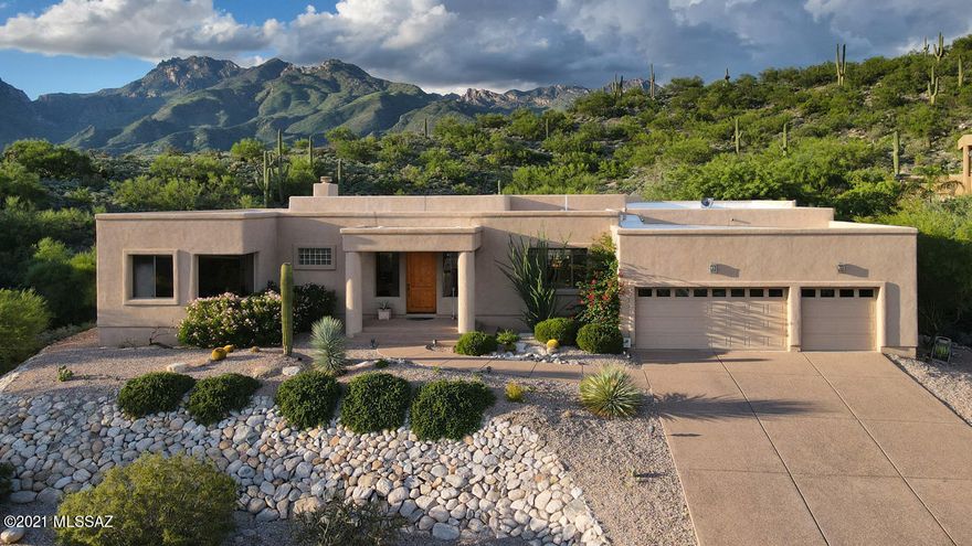 Elegance and tranquility welcome you to this gorgeous foothills home tucked away on a coveted private road with lush desert, nature, city and mountain views. This custom built, split bedroom plan with formal dining room as well as eat-in kitchen and enormous living room provides ample opportunity for any social engagement. Generous master suite boasts a large bath with soaking tub, separate tile shower, walk-in closet and its own phenomenal view that gives the feeling of having a mountain all to yourself. The pristinely curated, low care backyard also has a large covered patio that is plumbed with gas for a perfect BBQ set up. Stylish half bath and spacious garage round out this truly tremendous home. Conveniently located close to the finest shopping and dining the foothills has to offer.