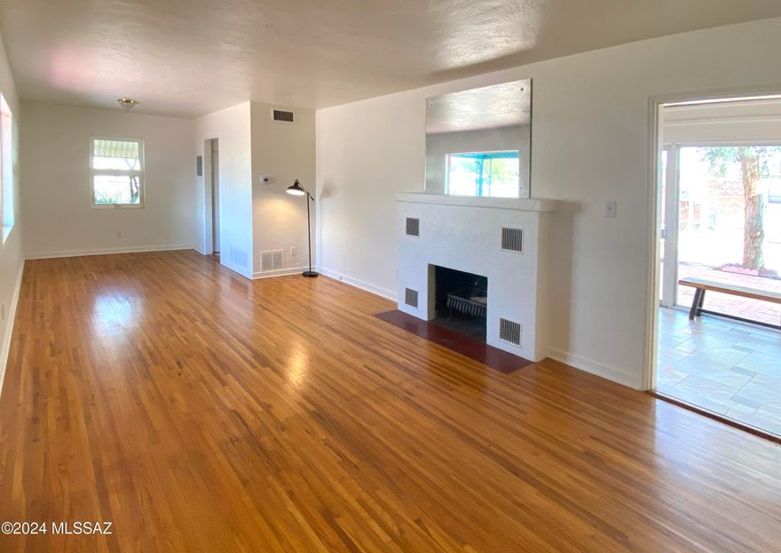 This classic brick bungalow & GH with original, pristine hardwood flooring throughout main living areas will not disappoint.  With its proximity to UofA campus, Banner Hosp, making it a popular choice for students, faculty, and university staff. Split living plan, 3 bedrooms, 2 bath, with a separate entrance for the large ensuite bedroom unit/bath, ideal for short or long-term rental prospect.  Brand new 4-ton AC on main home, brand new shingle roof on the guesthouse makes this property ready to go! Large galley kitchen has a retro Jenn-Air electric cooktop and separate wall oven, trash compactor, water filter, new hot water heater cap off this classic 40s bungalow. 
The separate guesthouse has a large living/work space, storage, large bathroom w/ walk in shower, great kitchen space. This entire property is secured by decorative metal gates and fencing, easy to add a motor and make the sliding gate automatic! a large covered carport and circular driveway.  Large separate yards offer each residence privacy.
Jefferson Park is known for its historic charm, featuring a mix of early to mid-20th century architecture. Many homes in the neighborhood reflect classic Southwestern styles, adding to the area's unique aesthetic.