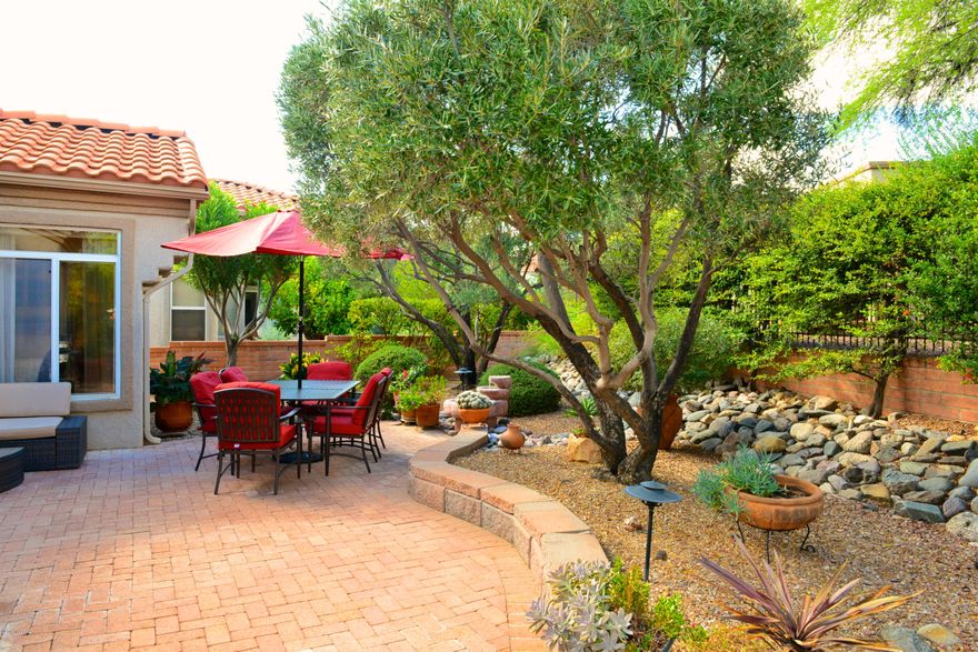 Enjoy peaceful indoor and outdoor living in this lovely move-in ready home!  This expanded light and bright Montara Model has a 2 bd/2ba split floor plan and additional den.  Warm ceramic tile throughout kitchen and living areas, berber carpet in bedrooms.  Kitchen is updated with maple cabinets and quartz counters.  Both bathrooms are also beautifully updated.  Spacious master bath has dual sinks and a large walk-in shower.  All hardware in the home has new brushed nickel finishes.  Charming north facing backyard with large brick paver patio and remote control awning for additional shade. Brand new roof with 5 yr warranty.  Driveway and garage are epoxy coated and the garage has ample built in storage. Hurry, this one won't last!