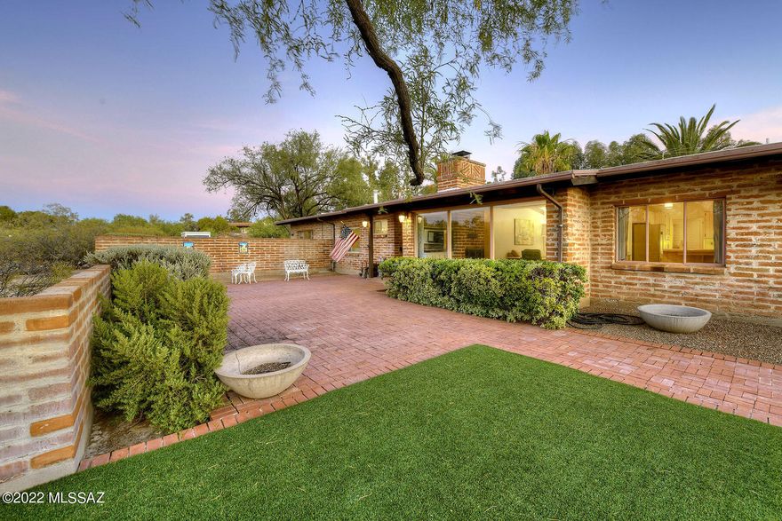 Sellers will consider offers from $850,000 - $925,000. This 1955 mid-century modern, burnt adobe one-owner home is nestled on a 1.12-acre corner lot in sought after Colonia Solana. The blank canvas is ready for your designs, updating and creativity! Designed by renowned architect Anne Rysdale, the charming ranch-style 2,815 sq. ft. main house offers 4 bedrooms and 4 baths. The generous guest house is 49' 5'' x 12' 9'' and includes a full bath. Enter the home through a grassed courtyard with brick pavers. Highlights of the home include a foyer with dramatic high beamed ceiling leading to the spacious great room/dining area with a wall of glass, a floor-to-ceiling burnt adobe fireplace, and a beamed & planked ceiling. The kitchen offers vintage tile countertops & cabinetry, a beamed & planked ceiling, and a breakfast area. The oversized laundry room includes a cloest, sink and a ¾ bath. All bedrooms boast beamed & planked ceilings. The gracious primary bedroom offers 3 closets. The 29' 8" x 13' 3" Arizona room, adjacent to the great room, features historic Mexican cement tile flooring. Enjoy the oasis-like back patio offering a expansive covered porch, an incomparable signature Whitaker pool with bridge, 2 covered ramadas, burnt adobe walls, and mature vegetation & trees. Walk to Reid Park, Hi Corbett Field or Broadway Village Shopping Center, restaurants and shops.