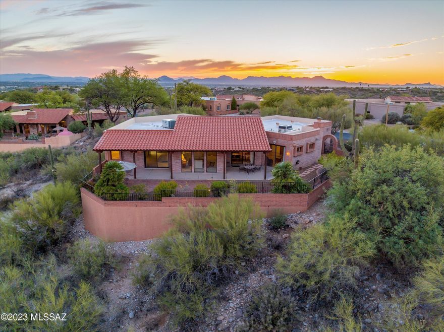Spacious 2,802 SQFT 2BR+Den Fairfield home sitting on a private 0.85 acre lot with breathtaking city and mountain views.  This Luxurious Catalina Foothills property features an open floor plan with soaring ceilings and expansive windows providing an abundance of natural light and panoramic views, custom remodeled kitchen with granite counters, stainless steel appliances, self-closing drawers & bar area, family room with romantic gas fireplace, gracious living room with wet bar, extended garage with storage closets and a Northeast facing low care backyard with a coverage patio running the length of the house all in a convenient location near shopping, restaurants and Sabino Canyon. Sunrise Territory Estates has a lighted tennis court, heated sparkling pool & spa, sidewalks and clubhouse.