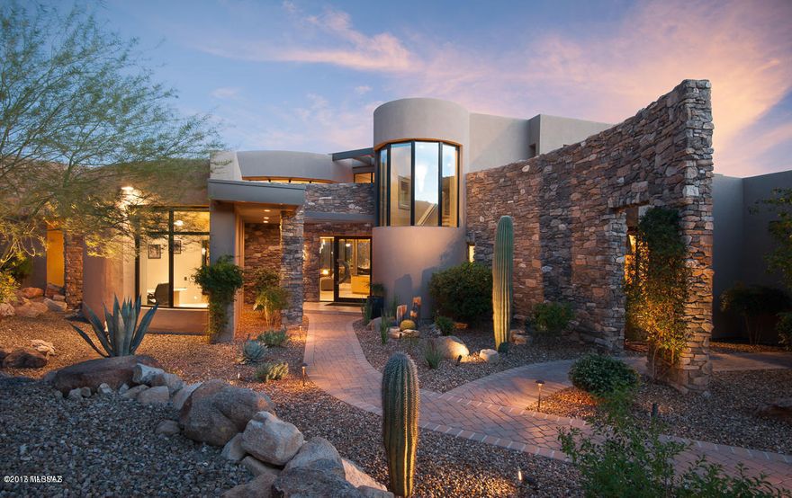 Timeless Contemporary Estate in the luxurious Stone Canyon Development. Exquisitely appointed with walls of glass seamlessly bringing the outdoor spaces in. Tranquil seating areas surrounded by elements of earth, fire and water. Enjoy 2 additional private secondary outdoor retreats: Perched seating with pathway for a peaceful morning coffee or meditation and roof deck which overlooks the desert fairways, unobstructed mountain view and city lights & outdoor fireplace. Owned electric solar panels providing affordable utilities. Interior is beautifully finished with unique contemporary materials and lighting. Grand upstairs Loft/Bonus Room/Exercise Room/Game Room/Bar Lounge with walkout covered patio and fireplace. The perfect space for your hearts desire. .