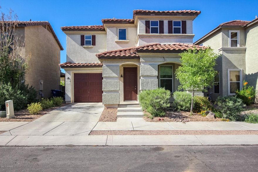 This exciting move-in ready home, featuring a newly painted interior throughout, boasts a large open layout downstairs with living room, den, 1/2 bath and under-stair storage room, and a BIG eat-in kitchen with pantry. Bring your extra large family to the dining table. Gorgeous tile counters, cherry cabinets, black Whirlpool appliances, custom upgraded fixtures, wood blinds and ceiling fans throughout the home. Four bedrooms upstairs boast brand new carpeting throughout and master has en-suite bathroom and walk-in closet. Large sliding doors lead to a cool covered patio with enclosed privacy block fence. New low-maintenance decorative landscape rock in the front & back yards.