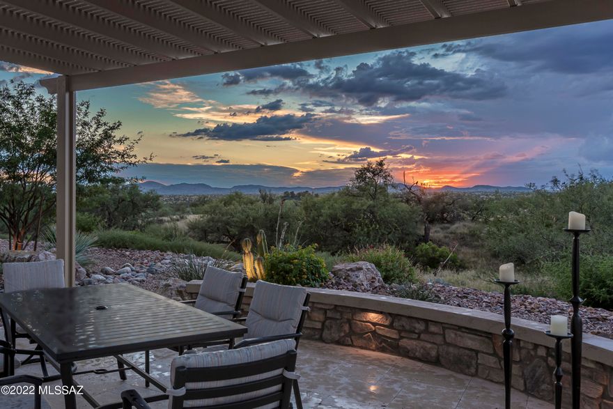 Discover a rare gem in this beautifully upgraded Vienta w/outstanding panoramic mountain view.  Delight in an extended travertine patio w/shady pergola & adjacent outdoor granite topped bar including BBQ.  Enjoy glorious sunsets under your covered patio w/gas fireplace & full rolling screens.  Inside you'll find a generous island & well appointed kitchen w/premium microwave & convection wall oven, range hood, under cabinet lighting, & reverse osmosis.  A side buffet by the great room makes entertaining easy while special 3M room darkening coated windows reduce glare.  Beautiful glass French doors at den.  Custom walk-in closets, framed mirrors, upgraded light fixtures, & full tile surrounds in both master & guest.  Epoxy coated garage floor & driveway w/golf cart garage & 4' added length.