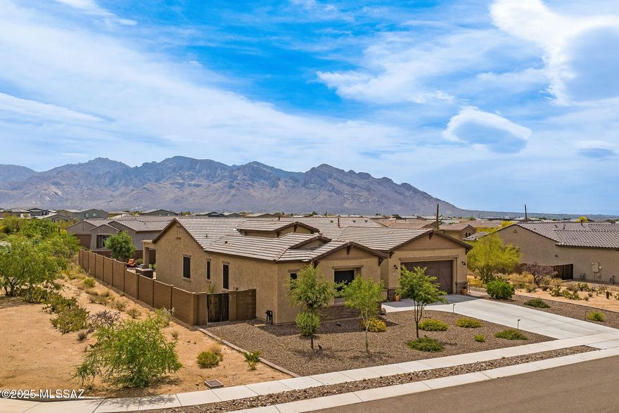 Don't miss this absolutely stunning home in the exclusive La Mirada gated community in Oro Valley! Recently constructed in 2021 by Pulte Homes, this ever-popular Rockledge model features 3 bedrooms, 2.5 bathrooms, a separate den/office, ample natural light, and tasteful touches throughout. You will find an abundance of upgrades, such as the custom iron front security door, whole home water softener and RO system, plantation shutters and remote-controlled blinds, built-in office cabinetry, and extensive landscaping. The dream kitchen boasts high-end Kitchen-Aid appliances including double ovens, 5-burner gas cooktop and range hood, microwave, and dishwasher, along with a vast walk-in pantry, soft-close cabinetry, and an oversized island with breakfast seating. Out back, relax and soak up the breathtaking views of the Santa Catalina Mountains under the spacious covered patio, around the built-in gas firepit, or with in a dip in the soothing hot tub. The home is situated on an expansive corner lot within the gated community, which allows for plenty of space between you and your neighbors. Both Wilson K-8 School and Ironwood Ridge High School are just a short walk away. Welcome home!