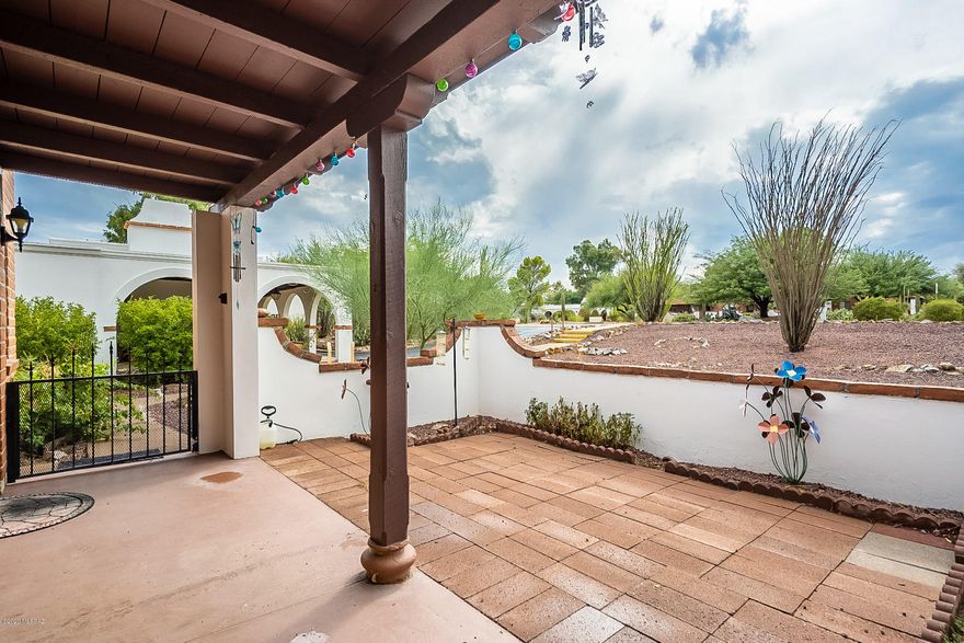 Welcome home!  Charming end unit in this popular Green Valley community with gorgeous  grounds and so many  amenities included.  Beautiful and move-in ready.  Courtyard entrance, full sized gas range and  full-sized side by SBS refrigerator, open and bright rooms, neutral color palette throughout, ceiling fans, assigned parking space for easy access, plus so much included within the HOA this is care free living at it's best!  Enjoy relaxing on the front porch with sunset views.  Community offers 2 pools, putting green, laundry facilities, park like setting with mature trees throughout. HOA covers HVAC unit, water heater, roof, exterior maintenance, exterior pest service, water, sewer, and trash collection.  Property is in GVR for you to enjoy all the perks.  Don't miss this one!