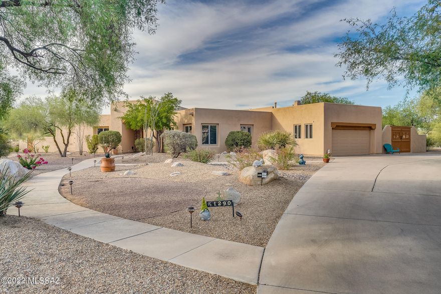 Beautiful, 4BD/2.5BA Oro Valley property with captivating mountain views in the desirable community of  Logan's Crossing. This immaculately maintained home sits on a private cul-de-sac and is full of absolute beauty on an acre of land.  Offering a split floor plan, spacious chef's kitchen with double ovens, gas cooktop, large island, pantry, and breakfast area. Open living room with formal dining includes natural light that shines throughout the abundance of large windows. Luxurious owner's suite and bathroom with huge walk in closet, two separate vanities, walk-in shower, and separate garden tub. Tons of storage with an oversized laundry room with utility sink and extra refrigerator.  Family room, kitchen combination with a cozy gas fireplace and built-in desk. This home boasts a lavish outdoor living space with a heated pool and spa with a water feature, mature landscaping and lovely pavers. Fully fenced backyard with a north facing patio for extra shade and gorgeous views all around. Recently painted interior and exterior. Roof recoated with a warranty. Close to schools, shops, restaurants, big stores, and Tucson city bike path! This beautiful and unique property is sure to check all of your boxes.