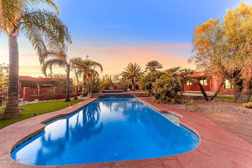 Welcome to a one-of-a-kind MASTERPIECE that truly redefines luxury living. This unique property, with 4297 square feet, offers a harmonious blend of elegance and comfort- in a highly desired foothills neighborhood. As you step inside, be captivated by the grand formal living room & separate dining room with mesquite wood floors & tall ceilings, perfect for hosting all size gatherings. Open kitchen, adorned with custom tiles, flows seamlessly into spacious breakfast nook & family room, all offering lovely views of the lush backyard. Vibrant & colorful home features four spacious bedrooms all with mesquite wood flooring & three full baths & the unique floor plan allows for endless customization to suit any lifestyle. Primary suite is a sanctuary unto itself ...SEE MORE TAB boasting a large fireplace & an opulent ensuite featuring venetian plaster, jetted tub, and a massive walk-in steam shower. A spiral staircase leads to a massive second level closet suite with windows that could be converted into doors for a patio or balcony space.
On the opposite side of the home, discover a large guest suite with an adjacent full bath & a separate room transformed into a walk-in closet. With hidden gems at every turn- such as secret access to the Arizona room- this home is filled with fairytale charm. In addition, the large custom wood doors & unique finishes of every room truly adds to the old-world feel of this home. Arizona room opens onto a large, fully enclosed yard- ideal for pets. Attached one-car garage offers versatile space for a workshop or workout room, while a separate two-car garage & fenced yard enhance convenience. Outdoors, picturesque gazebos & trellises lead to a serene tucked-away spot featuring a built-in fireplace & waterfall pond. Within the fence, the expansive yard is a paradise with a sparkling pool, separate hot tub, & exquisite landscaping, including fruit-bearing trees. Nestled on a secluded .85-acre lot, this property is a private oasis waiting to be called home. Foothills (district 16) School district. Close to shopping, schools, recreation & more. Welcome in...