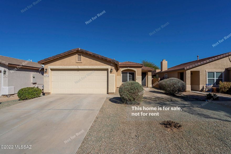 This Tucson one-story home offers a two-car garage.
