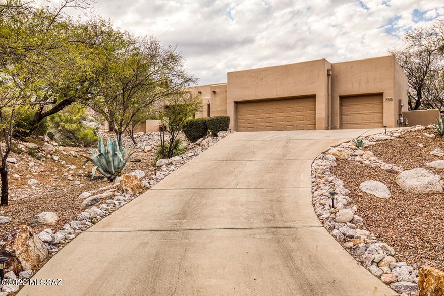 Located in the highly desired Ventana Ridge gated community, this masterfully designed home creates the perfect setting for everyday living and entertaining. The main living areas are flooded with natural light from the walls of windows throughout the home, accentuating the gorgeous wooden beams and giving visual access to the beautiful desert that surrounds. The primary suite is situated in its own wing of the house apart from the great room and guest suites and boasts a large walk in closet, garden tub, walk in shower, and direct access to its own backyard patio area. Beautifully designed great room allows for easy entertaining as you look out to the Catalinas, and the oversized three car garage is an added bonus. Home is located close to Sabino Canyon, Ventana, and much more.
