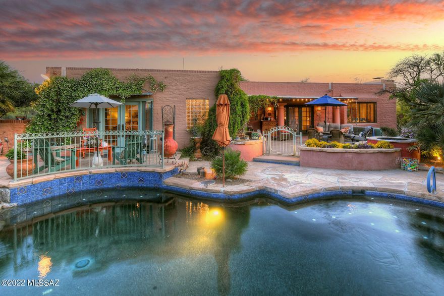 Private gate & paver driveway lead to this stunning burnt adobe with gorgeous mountain views. La Quinta built masterpiece nestled on 1 acre in Catalina Foothills Estates 8. Custom paint, refurbished woodwork & doors throughout, high ceilings & signature corbels create a feeling of warmth. The foyer opens into a dining area with a one-of-a-kind custom table & chairs (that conveys) next to the sunken living room with picture window, tile floors, plantation shutters, converted gas fireplace & vintage chandelier. Primary ensuite looks out onto the backyard through French doors with pewter hardware while the bath features concrete counters, purple glass basin, heated floors & a six head steam shower. The kitchen boasts wood floors, granite counters with Talavera tile, inlaid ... see MORE tab ... inlaid Mexican murals along with a 5-burner gas range, Dacor warmer drawer, coffee bar, bistro counter, custom lighting & anti-bacterial sink. The resort style backyard beckons with stunning Catalina views, water feature wall and pool waterfall. Mature landscape, desert plantings that include over 40 saguaros surrounding the brand new Pebble Tec pool, once featured in Sunset Magazine. Private acre, Catalina views & landscape lighting are unsurpassed. New HVAC, hot water heater, roof recoated and clay tile replaced. Every inch of this home has been upgraded, cared for & loved. Catalina Foothills District 16 schools! Close to everything while feeling worlds away in your private retreat. Please see the upgrade/features list to get a real feel for what has been done to make this house your new home.