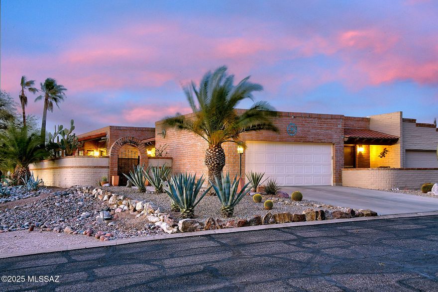 Nestled in the highly sought-after Fairfield community, this beautifully updated 2-bedroom plus den, 2-bath townhome offers over 2,000 sq ft of luxurious living space with breathtaking Catalina Mountain views and sparkling city lights. Step inside to find an exquisite kitchen featuring a Viking gas oven & hood, a Fisher & Paykel 2-drawer dishwasher, custom cabinetry with pull-out drawers, and soft-close hardware. Stunning granite countertops and a large picture window create an inviting space for both cooking and entertaining. The kitchen opens seamlessly into the spacious dining area, while the newly designed fireplace adds charm and warmth to the generous living room. The main areas are adorned with beautiful travertine flooring and large skylights that flood the space with natural light. A private  den/office with built-ins and double doors offers an ideal space for for remote work or relaxation. Throughout the home, you'll find solid wood doors that add a touch of elegance to every room. Both bathrooms have been fully remodeled with high-end fixtures, gorgeous tile surrounds, and granite countertops. The primary suite is a true retreat, featuring a jetted tub, separate shower, abundant storage, and a custom walk-in closet you'll absolutely love. The guest bedroom includes a private patio and a custom closet, adding extra appeal and functionality. The home also boats additional storage in the garage, including built-in cabinets and a utility sink, along with coated floors for easy maintenance. Convenient features like a central vacuum system, a tankless water heater, and a new water softener provide added comfort and efficiency. Enjoy the stunning outdoor space with a wraparound patio, artificial turf, and panoramic mountain views. The front courtyard provides additional outdoor space for relaxation, while the community amenities include  tennis courts, pool, and spa.This townhome offers the perfect blend of modern luxury, convenience, and privacydon't miss out on this incredible opportunity to own in one of Fairfield's most desirable neighborhoods!