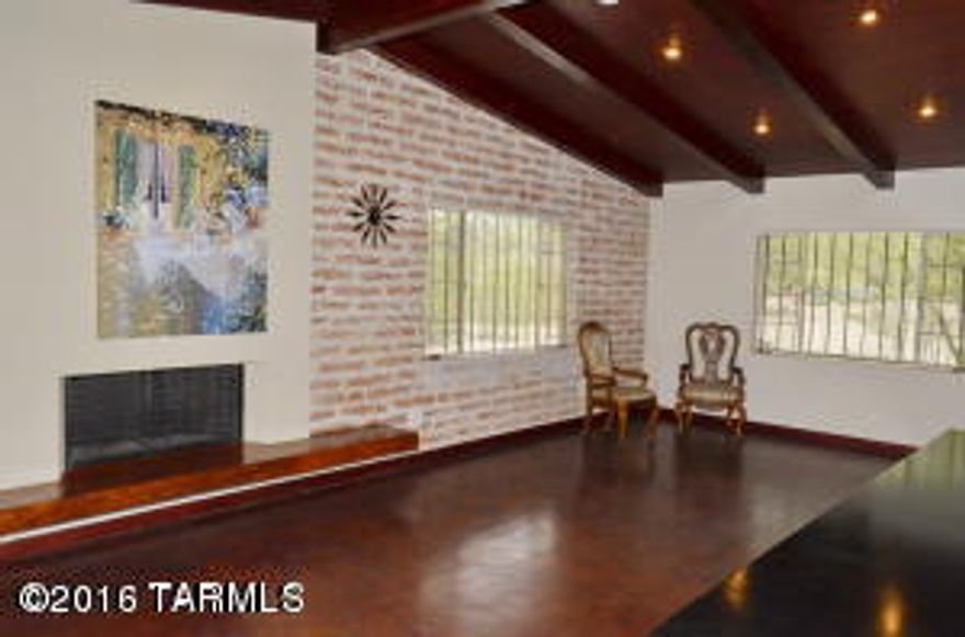 Featured in Tucson Lifestyles..., Winner by Agents for Best House!! $200,000 Upgrades. Historic TAX BENEFITS. Located on over 1/2 Acre.7 Fruit Trees hidden behind hedge on South side of property. Large covered patio. Huge Storage/workshop area, COMMERICAL KITCHEN with Cherrywood 12' Beamed ceilings in Great Room. Cherrywood cabinetry is mind blowing-even in the Master Bathroom. Two bedrooms have been expanded with large closet and sitting areas. Sought after...hidden subdivision...few minutes from major mall and 2 hospitals. Ceilings in house were changed from 7' to 12' with insulation added between the new ceiling and roof. Burnt Adobe structure was top of the line blocks from New Mexico. mountain Views. This is what most buyers want that is Central Tucson for much less money--yet the Central Area is just across the street so...show to your Central Buyers!!! Great Walking Village where people seem to stay for many decades.