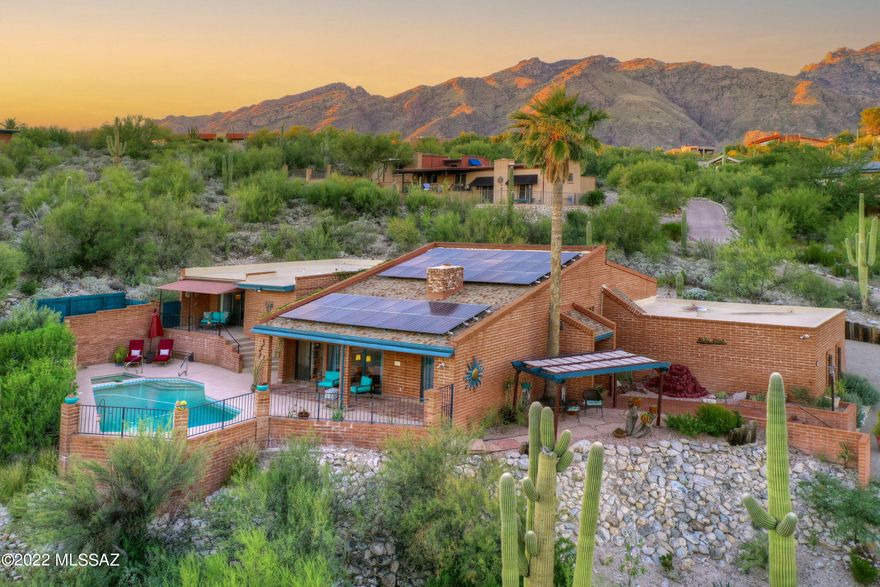 You will be impressed by the inspiring architectural design of this territorial home which is situated in the sought-after prestigious neighborhood of Cimarron and District 19 schools. Perched atop a hill, this home offers captivating panoramic mountain and city views, sparkling pool/spa with multiple vantage points to take in the picturesque views! The spacious updated kitchen includes cooktop island, granite counter tops and SS appliances with plenty of storage, in addition to, a separate walk-in pantry. The updated owner's suite features a beautifully tiled, walk-in shower, a dual sink vanity and a large walk-in closet with a second traditional closet. Additionally, enjoy your own private elevated covered veranda to take in the views. A guest room/den features built-ins including a Murphy bed while the spacious Arizona Room and second large patio courtyard off the kitchen makes this home an entertainer's dream.