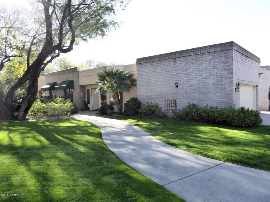 A spectacular Zero-lot-line home which was the original Model Home. Very high quality and immaculate condition. Updated kitchen with granite tops and stainless appliances. Features 2 bedrooms plus an office and a small exercise room. One of the best lots in the subdivision which adjoins community pool and large green lawn which is maintained by the association. Good size rear yard has built in grill and overlooks the Rillito River Path. This is a very special property!