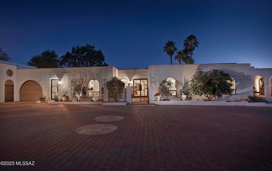 An incredible opportunity awaits in the coveted Catalina Foothills! This meticulously renovated 5 Bed/4 Bath estate, remodeled to perfection, presents an unparalleled level of comfort and sophistication. Boasting breathtaking city and mountain views, this residence offers an oasis of tranquility in a desirable Foothills location near Tucson's most exclusive shopping, dining, galleries, and Country Clubs. Updates abound in this remarkable home, including new HVAC, new plumbing, new premium water filtration system, new instant hot water, new interior doors and windows, and new sewer line with 50-year warranty. Step inside the new custom glass and metal entry doors to be welcomed by an open floor plan with walls of windows showcasing city views. The polished concrete floors exude modern elegance and timeless appeal. The kitchen, equipped with top-of-the-line appliances, quartz countertops, and large island, is open to the family room with pool views, while a butler's pantry boasts an additional oven, sink, dishwasher, storage, and convenient hookups for a supplemental washer and dryer. The impressive owners' suite features a gas fireplace, 2 walk-in closets, and home gym. This stunning property also features a charming 1 Bedroom Casita with a private patio and fountain that will surely enchant your guests, or use it as studio or office space.  The backyard is an entertainer's dream with a covered patio, artificial turf putting green, pebbletec pool and spa, and a built-in BBQ area for outdoor gatherings - all complemented by magnificent city views. The expansive garages will delight car enthusiasts with ample space to accommodate 6 cars, plus workshop, engine hoist and room for 2 lifts. Owned solar panels ensure low electric bills, and a water harvesting cistern system contribute to the property's eco-friendliness and cost efficiency. This exquisite property has been thoughtfully improved and meticulously maintained, offering a turnkey solution for those seeking the epitome of the luxury desert lifestyle. With a voluntary HOA and the impressive host of recent enhancements, this home presents an outstanding value proposition. Don't miss this opportunity to own a piece of Catalina Foothills paradise at a new attractive list price. Contact us today for a private tour and see the full list of recent improvements that make this property an unparalleled gem in this prestigious area.