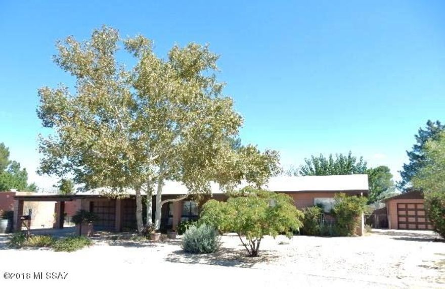 Quiet Street. Home shows Owner Pride thruout.   Remodeled upgraded KITCHEN with all Stainless Steel Appliances that stay. Rustic Oak  Cabinets, New lightning ,Kitchen Island.   3 bedrm 2 bath with Large Living room and Family Room with cozy Wood burning fireplace . Newly  Tiled Thruout .   New Windows with Anderson Patio Door to back yard.   Large Workshop  Detached for all your projects  .  Property nicely landscaped with huge backyard that overlooks Old golf Course.   Covered Patios Front and Back.  Backyard chainlinked fencing.    2 car  attached garage with a 2 carport in front .