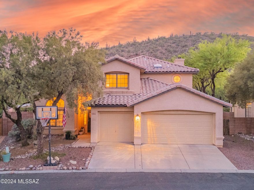 Introducing a splendid residence nestled in the serene community of Tierra Santa, situated on a peaceful cul-de-sac within the vibrant Catalina Foothills. This remarkable home harmonizes style and practicality seamlessly, both indoors and out. Positioned on a private .21-acre lot, it boasts a backyard haven overlooking a verdant expanse of common area and mountain vistas.  With swimming season on the horizon, this home is perfectly poised for enjoyment, featuring a refreshing pool, a shaded patio, and lush turf. The heart of the home, the updated kitchen, is a culinary enthusiast's dream, equipped with stainless appliances, rich mahogany cabinetry, granite countertops,   brick backsplash and a sunlit breakfast nook.  Flowing effortlessly from the kitchen, the family room offers. a cozy retreat with a fireplace adorned by a charming tumbled travertine hearth and beamed accents. The architecturally engaging layout showcases soaring 15-foot ceilings, a striking circular staircase, an inviting foyer, custom built-in bookcases, Plantation shutters, and abundant natural light throughout.  Further enhancements include Italian porcelain tile flooring, renovated bathrooms, and a generous primary suite boasting a dual vanity, garden tub, separate shower, and a spacious walk-in closet. Ideally situated within the sought-after District 16 schools, this coveted residence offers proximity to Sabino Canyon, desirable amenities, restaurants, and scenic hiking trails.