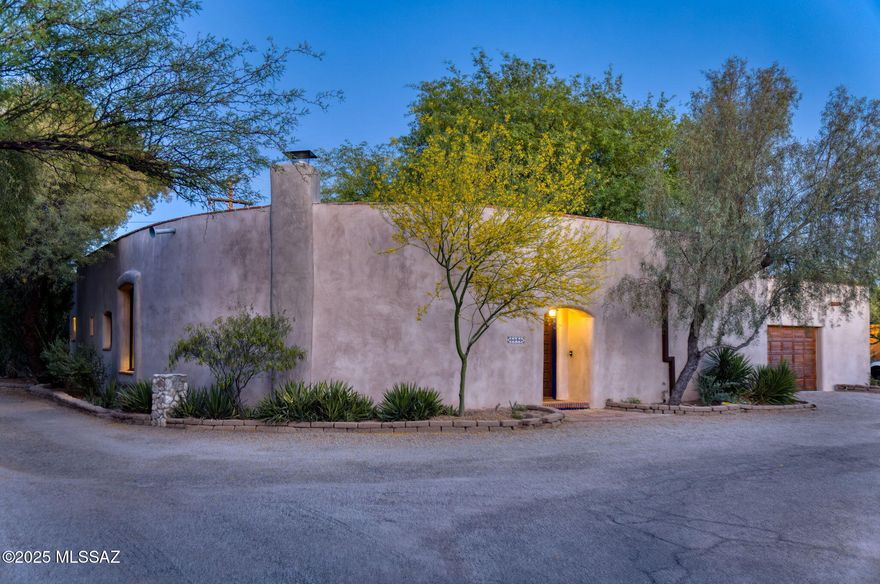 Private & secluded this authentic mud adobe is nestled in a hidden enclave in the Ft. Lowell Historic District that transports you to San Miguel de Allende. Here you'll discover a perfect blend of hand-crafted construction techniques using natural materials w/modern comforts. Split floor plan features soaring wood-beamed ceilings, abundant natural light w/beautiful open living, dining, kitchen & breakfast areas. Masonry fireplace w/ sweeping hearth, gleaming brick paver floors & walls of glass open to a lush courtyard w/ pool, shaded porch & mesquite grove. Generous primary suite features sitting area & glass-door private access to rear outdoor spaces. Recent upgrades incl hand-crafted alder cabinetry/storage in primary bath, enclosed garage w/ new windows & custom wood door. Spectacular!