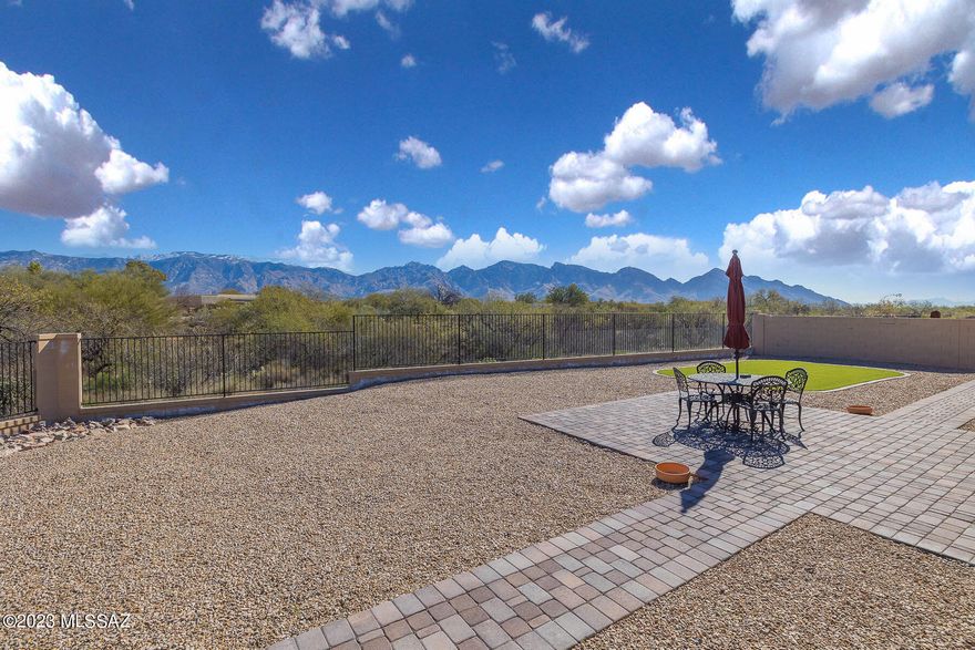 Spectacular panoramic views from this striking, highly upgraded 4BR/3.5BA (3,295 sq ft) gated home in Center Pointe Vistoso. Large cul-de-sac lot backs to Vistoso Trails Nature Preserve. Brick paver drive flows to large gathering room w/porcelain tile and 10' ceilings. Gourmet kitchen hosts island, breakfast bar/nook and high-end appliances. Enjoy a dining room, den/office and split bedroom plan w/guest & teen quarters. Upgraded Owner's suite hosts luxury bath w/huge walk-in closet. Recently painted interior. Newer flooring/appliances/LED lighting/windows/sliding patio doors/French doors. Heated/cooled 3-car tandem garage w/Tesla outlet. Extended rear patio w/brick pavers plus large turf area and view fence. Center Pointe Park has clubhouse, pool/spa/splashpad, firepit patios & playground.