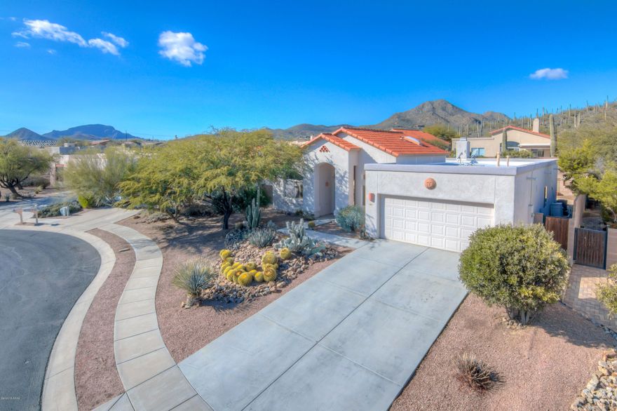 You must not miss this meticulously maintained 3BR/2BA home with large den, formal dining and great room concept off kitchen. This quiet gated community is directly across from the Starr Pass Community, Golf, and Resort. Minutes from downtown & University of Arizona. Custom upgrades include wood entry door, hardware & fixtures, tile throughout, plantation shutters, surround sound, Large Greatroom off kitchen, complete with cozy fireplace! Jetted tub in master bath, with huge walk-in closet. Heated pool and spa w/recently coated kool decking, and new heater. Built-in gas BBQ, fire pit, and covered patio make this backyard oasis your quiet and relaxing escape. This is a MUST SEE home that will not last. Come visit your new home today!