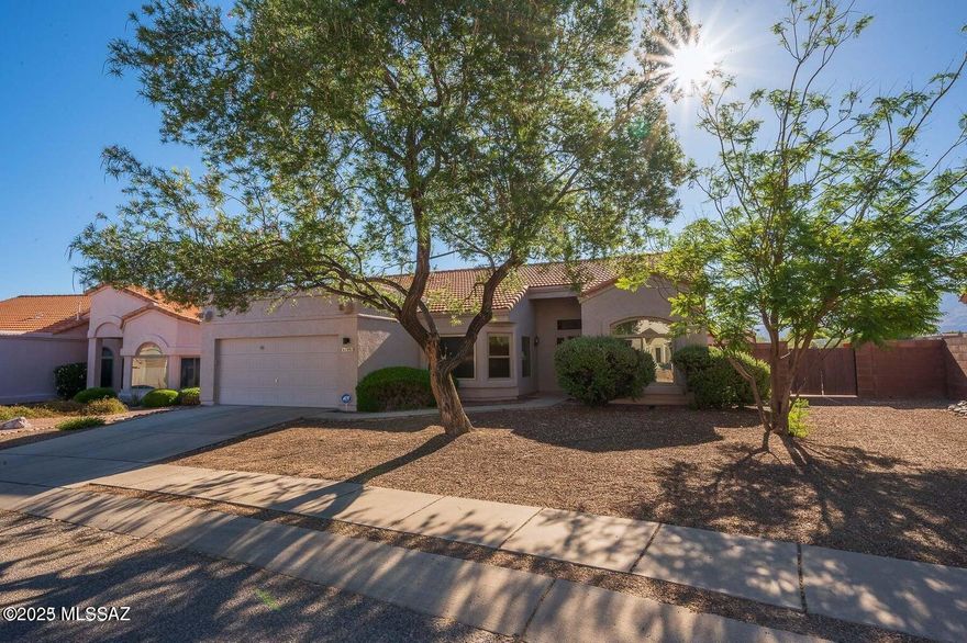 Spectacular Panoramic View of Rincon & Catalina Mountains. .44 acres!! Open and spacious, split floor plan! Completely updated! Envy of the neighborhood! HUGE back yard that backs to desert arroyo (that's right... no neighbors behind you). The back-yard retreat offers an endless entertaining vibe, to include tasteful landscape throughout, brick pavers, cement/concrete slabs, special seating arrangement for your guests. For the Golf Enthusiasts... your own Private Putting Green coupled with artificial grass... and a refreshing/relaxing in-ground pebble tec jacuzzi spa for those cozy cool nights of star-gazing! The side yard offers a large HOA approved wood workshop/work storage. The double gate access to your back yard is wide enough to roll a 4x6 utility trailer and/or your small RV toys! The inside... is tastefully updated and decorated with a HUGE Great Room, a wood burning fireplace, large Pella windows and large 8ft sliding glass door allow you to enjoy the beautiful Rincon Mountains. The home boasts vaulted ceilings and offers a large beautiful ceiling fan! The kitchen has been updated with new granite counters, stainless steel appliances, new window bay blinds in dining/nook area, skylight and new floor tile. The primary bathroom has been completely updated/renovated: new cabinet/top/fixture, new large format tile in shower/tub surround and new floor tile, and new shower/tub fixture system. This lovely and spacious home offers a split floor plan. The Master-Suite is HUGE and offers large Pella windows overlooking the Rincon Mountains and a large beautiful ceiling fan. The master bathroom has been completely updated/renovated with beautiful new 72" vanity cabinet with double sink and tasteful inlaid tile counter-top. You'll love all of the tasteful tile work throughout, to include in the large walk-in shower. Relax in your Mr Steam personal home steam/sauna room, which can also function as a secondary shower enclosure. The flooring was also recently updated with a beautiful diagonal tile layout. Large walk-in closet. Light & bright with lots of  large windows throughout. All windows in the house were updated with dual pane Pella Brand windows! In 2021 a new Pentair/Hayward filtration system was installed for the outdoor in-ground jacuzzi. The interior of home has been freshly painted with neutral color paint throughout. New 40gal gas hot water heater installed 2025. The HVAC unit is a TRANE and runs impeccably. The home offers a salt soft water system which works as it should, but is not currently being used. The home is clean, updated, turn-key and ready for new owners to enjoy! Calling all winter visitors.. it's move in ready to include furnishings if desired!! This is a very nice home with an amazing and entertaining back yard vibe! Oh and no homes behind you! The Silverado Hills Community is well sought after, established, quiet, well kept, private, neighborly and surrounded by lots of natural desert scenery and abundant wild life. Don't miss out on this one! Ready for immediate move-in and enjoyment.. The furnishings can convey if desired. One of the owners on deed is a licensed realtor.
