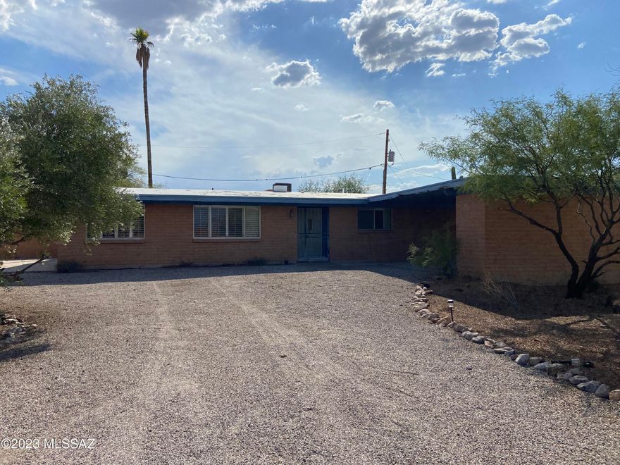 West Tucson ranch style home on a BIG lot. 	0.403 acre lot has lots of room for parking for all your cars and toys, even for an RV.  Attached two car carport with storage. Big backyard with pool and out building. Views of the Santa Catalina mountains from the front yard and driveway. Yes, the home needs some TLC but with a little work you can make it your own. Interior features 3 bedrooms, 2 bathrooms and 1,649 sq ft. Fireplace, tile flooring and vaulted ceilings. Primary bedroom has 3/4 bathroom. Family room and formal dining room too. Located at the end of a quiet cul-de-sac, this home has the room you need and the privacy you want. Come see for yourself!