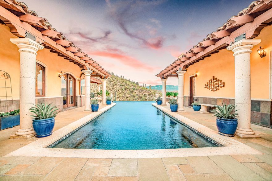 Perched high in NE Tucson in gated Milagrosa Hills, the view from this Tuscan Estate is like no other. Resting on just over 6 acres, experience the tranquility of living on top of the world. Extensively remodeled/rebuilt from top to bottom this 5,823 square foot home boasts 5 bedrooms, 5 well appointed bathrooms, a private gym & 4 car garage to fulfill all your desires. The chef's kitchen & butler's pantry are everything with multiple Sub Z's, LaCornue range, Landry Poplar custom copper hood, & more! The 1,200+ sqft owners retreat offers a private patio, accordion glass door access to the pool beckoning you to never leave. All custom mahogany woodwork throughout the home & an extensive amount of natural stone used inside & out. Extra lot would be great for horse facilities or guest house.