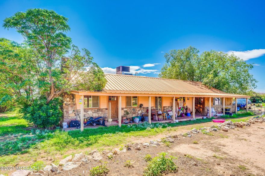LET THE PREVIOUS BUYERS BREACH BE YOUR GAIN! Working Cattle Ranch at the road's end that backs up to the Dragoon Mountains, featuring 10,000+ acres (~600 Ac Deeded, ~2,100 Ac State Lease & ~7,500 Ac USDA Grazing Permit). 10,000 Gal concrete water storage tank, automatic watering, 2 private registered wells (including 1 irrigation well of ~1,200' deep w/ 3-phase power) & side roll irrigation equipment. 8 pens/corrals w/ squeeze chute, 3 pastures, plus additional enclosed areas equipped to contain livestock. Several outbuildings, including ~1,560 SqFt (~60' x 26') metal hay storage building/livestock shelter that could also serve as covered parking for vehicles/equipment. Lovely mature trees surround the rustic 1,783 sqft home. Home & Well Inspection reports available to QUALIFIED buyers.