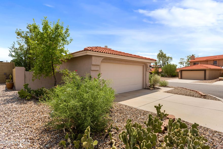 This charming 3-bedroom, 2-bath home features a desirable split floor plan and vaulted ceilings, offering a spacious and open living environment. The interior and exterior have been freshly painted, enhancing the home's curb appeal and move-in readiness. The beautifully landscaped yard provides a serene outdoor space, complemented by a covered patio perfect for relaxation or entertaining. Located within the Marana School District, this property is ideal for families and is conveniently situated near shopping centers, making daily errands a breeze.