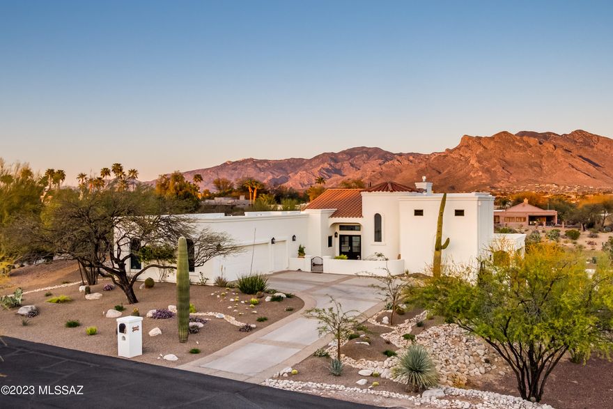 Located within gated Omni Tucson National, this home sits on the 18th fairway of the Sonoran course. Totally professionally renovated & updated in 2022. Interior Design & Vision by Michelle Carnes Design. Brendan Guthrie, General Contractor. Priceless views of the Catalina's from inside as well as from the sweeping patios across the entire east side of the home. Practice your putting on your own backyard green.  Enjoy a dip in your pool or sit by the outdoor fireplace to watch the mountains turn pink. Tuck your own golf cart in its very own garage. Huge storage room with shelving at back of the oversize garage. This home will inspire the most discerning homebuyer. Omni memberships available for enjoying all the resort amenities. See Document tab for incredible amenities