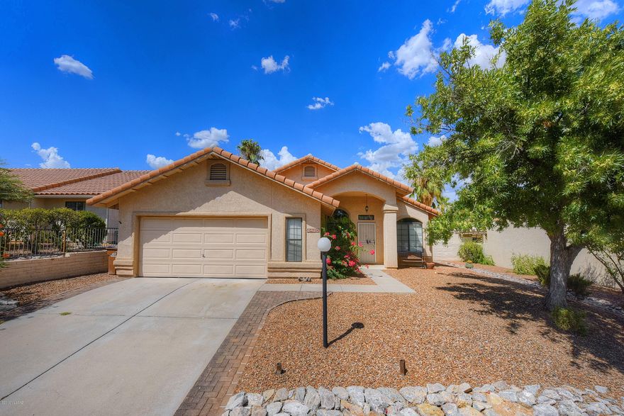 Beautiful, completely remodeled in a Northwest Gated community.  Formal living and dining room with office/den!!! Family room with cozy fireplace and open kitchen.  New, stylish tile throughout with fresh carpet.  Both bathrooms updated with designer touches. New vanities, toilets, pattern floor tiles and herringbone pattern tile in showers & tub surrounds.  Elegant kitchen with lots of cabinets, large island with granite counter tops, new Samsung gas stove, dishwasher, microwave & refrigerator.  2 car over-sized garage with plenty of storage. Good sized yard with mountain views and privacy.