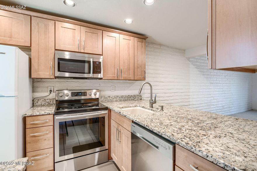 This fabulous Eastside Townhome has 4 bedrooms (3 regular sized rooms, and 1 that could be a den or office), 2 full bathrooms, and a community pool. Updated kitchen with granite countertops, beautiful cabinets, dual-pane windows, single basin sink, bathroom vanities, and master shower. Private patio off the living room. HOA fee includes water, trash, common area landscaping & pool area. Welcome home!