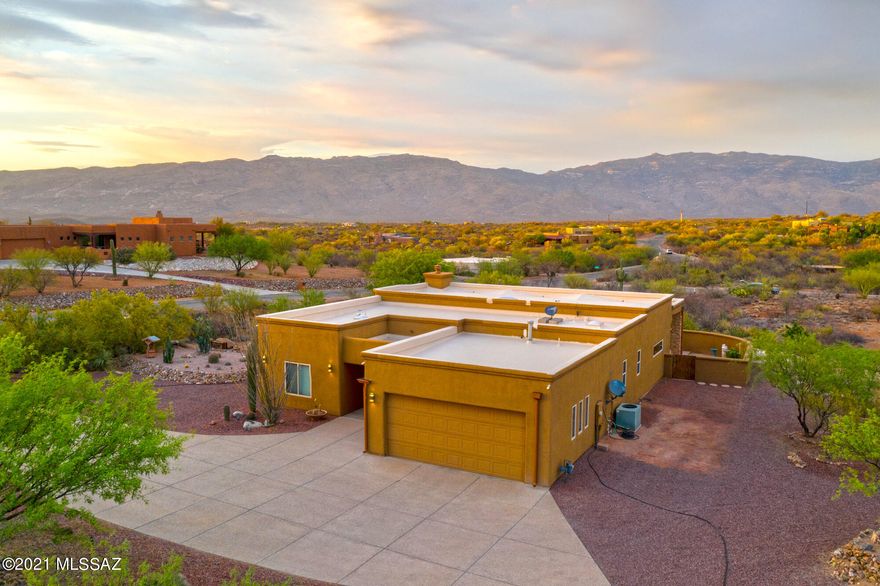 Sitting on 1.7 acres, this house was built to feature the Rincon Mountain views from the back windows and patio, including the beauty and peace of the desert that goes along with in! Enjoy the full length covered patio and extended brick patio with stacked stone columns whether you are entertaining or just enjoying some quiet time for yourself. Step through the custom iron and glass front door and you find the gorgeous wood beam ceiling in the great room, gas fireplace and solid alder doors throughout. Beautiful kitchen with raised panel wood cabinets, skylight and of course granite counters. The spa like master bath has a jetted tub, walk in tiled shower, dual sinks with custom plumbing and separate vanity area. Claim your piece and peace of the desert now!