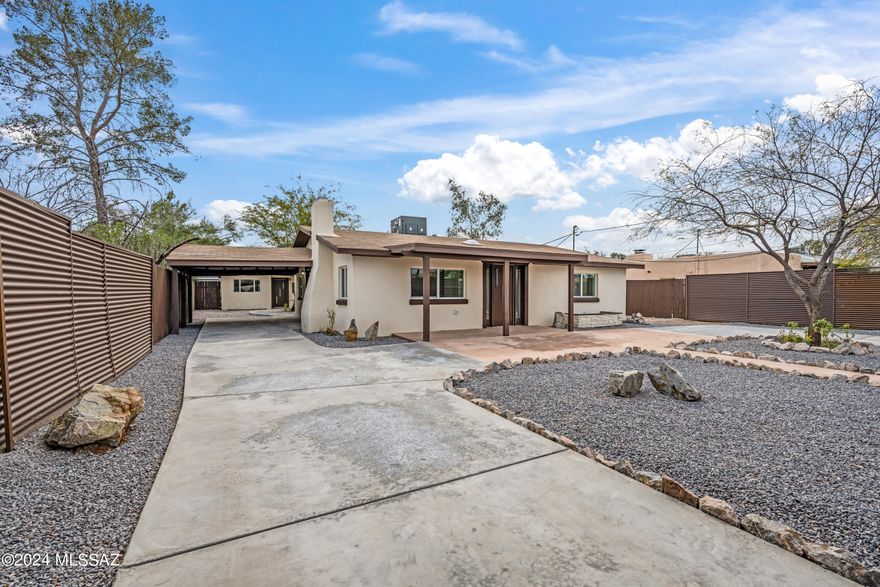 Privacy, location, flexibility... This property has everything you're looking for and more! Guarding the entrance is a custom steel gate, motorized to open remotely from the push of a button. Inside the gate, a freshly paved wrap around driveway with a separate covered carport which provides easy access and ample space for parking. Low-care gravel landscape with plenty of room for pets and toys. Both units boast tasteful updates and modern styling, with gorgeous granite counters to pull everything together. Breathtaking mountain views to enjoy all year round. Second unit is perfect for accommodating family, guests, or generating extra income. No HOA! Prime central location provides close proximity to all the amenities you need. Don't miss the chance to make this unique gem your own!