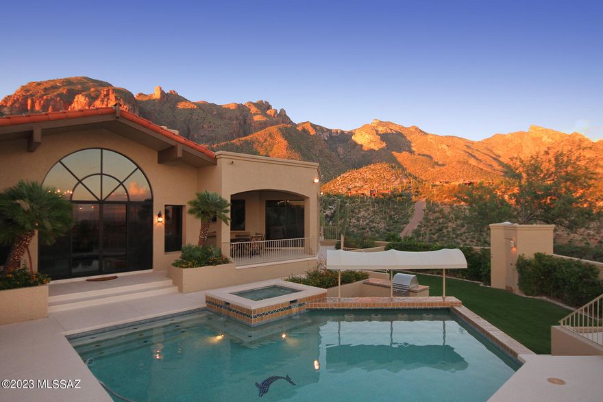 Breathtaking City and Mountain views from this spectacular home. Situated high on a bluff overlooking all of Tucson in the beautiful Catalina Mountains. Perfectly updated and immaculately presented. This property has amazing views from every window. Swim up pool bar and built in BBQ accent some of the special places to enjoy this exclusive guard gated Cobblestone setting. Just minutes from world class shopping and restaurants with easy access to the University of Arizona and Downtown.