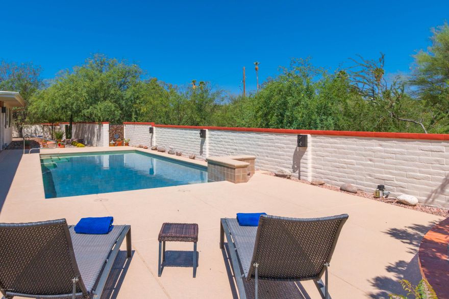 Meticulously maintained home with extensive upgrades by Seller is located in desired northwest area in a private cul-de-sac and backed up to a wash. The functional floor plan is perfect for entertaining with room for business or hobbies. This warm and welcoming home has multiple sliders that create a wall of viewing into the private and tranquil backyard with a Pebble Tec pool, dual water falls and a spacious patio. There are 3 beautiful bedroom, 2 bathrooms and an updated kitchen with a granite island counter, new appliances and 2 pantries. The formal living room and dining share a dual sided fireplace, Swiss & Martin shutters, 2 car garage w/storage cabinet, also a separate block structure with electricity for Multipurpose. View Documents for Upgrade List!