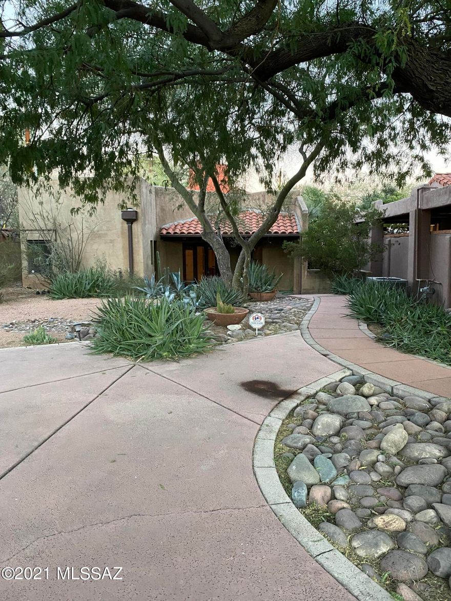 Very Private residence in desirable Sam Hughes. This relaxing home is alive with original Southwest desert touches, Cobalt blue, Terracotta, Earth browns and pale palomino colors welcome you home in this relaxing property.  2 Br 1 & 1/2 Ba. Open floorplan, Kitchen with all appliances. Saltillo Tile flooring and amazing Saguaro Rib Ceilings in main living areas. 2 Fireplaces, Family Room and Master Bedroom.  Cathedral Height rear foyer hallway leads to multi level patio areas. Laundry room includes washer and dryer Solid Plank Beamed ceiling in Master Bath with sunken Tub and walk in shower. Home is set back from street providing an enchanting shaded front entrance yard. Enter the split level rear yard and Covered Carport. Enjoy the privacy. Pet considered with prior Owner approval