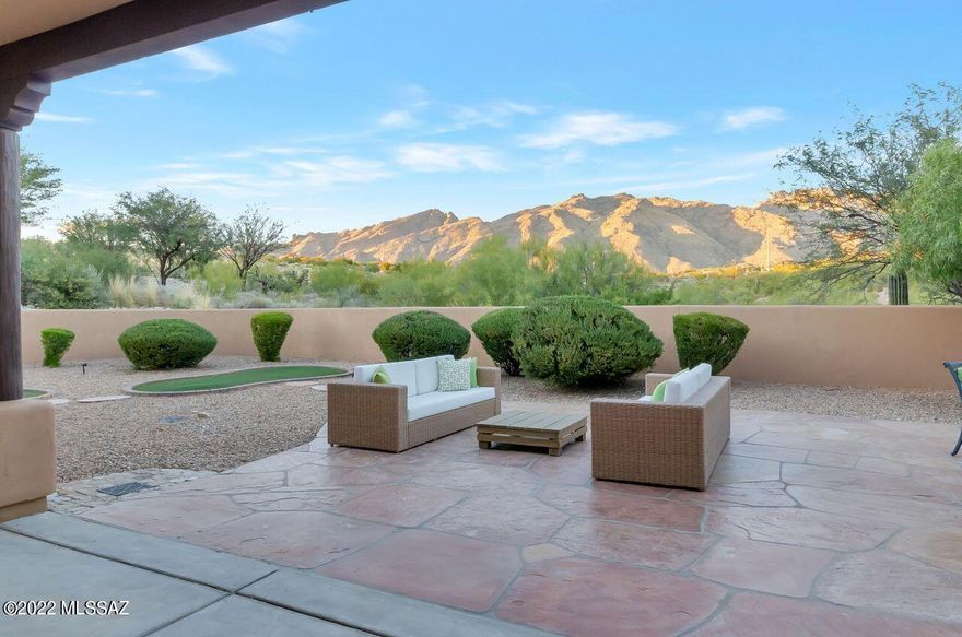 This private enclave gated community with only five custom home residence. You will be enthralled with all the custom features and the elegance of this property. Starting off with travertine floors throughout the property, 15-foot ceilings with Vega beams and corbels formal dining room and living room with a gas fireplace and a sliding glass door that leads to this amazing outdoor patio with an outdoor kitchen. Flagstone floors and countertops on the outdoor, BBQ, a putting green and the most magnificent mountain views you will ever experience in the whole city. Breathtaking is an understatement. Wraparound covered patio. Separate kitchen with a spacious breakfast nook and a large family room with built-in cabinetry and speakers for surround sound. The kitchen has a new LG refrigerator a double oven with a convection component to it a separate stainless-steel microwave and a gas cooktop with four burners. The backsplash is tumbled marble and the countertops are a gorgeous neutral colored granite All the cabinetry throughout the property is raised panel with a glaze. Double door deep pantry in the kitchen and a very large laundry room with whirlpool washer and dryer cabinetry above and a separate sink with granite countertops completes the perfect laundry room a very large and expensive three car garage with several closets that are for additional storage in the garage there is a additional door that allows you to exit into the backyard. the most breathtaking Catalina foothills mountain views that are showstoppers. Sliding glass doors throughout the property and large massive windows so that you can enjoy the indoor-outdoor living

This home has so much to offer Custom Cabinets with race panel and glaze tucked in through several corners of the property again for additional storage bedrooms with built-ins to add beautiful Decor pieces.

Bathrooms with tumble marble countertops and tumble marble travertine surround from floor to ceiling. And surround sound speakers throughout the property.
the primary suite glamour and luxury with an extra-large bedroom with a very large picture window of the Catalina foothills Mountain View a French door that leads out to the patio Vega beams in the primary suite as well to add a touch of custom detail. The primary bathroom has a double vanity with travertine countertops a deep soaking tub and a extensively large walk-in shower with double heads. Very luxurious. The walk-in closet in the primary house built-ins and plenty room to display his and her wardrobe. A separate water closet. this house will not disappoint you. On the contrary

You feel the elegance and the luxury of the spectacular home from the second you step foot in the home. Extensive covered patio in the entry that allows you to enjoy beautiful sunset views. Elegance style privacy custom property A rare find in today's times in the foothills. Views like this you can only dream of. As a homeowner you will wake up every day greeted by the Catalina foothills mountains and every single public room of the house.