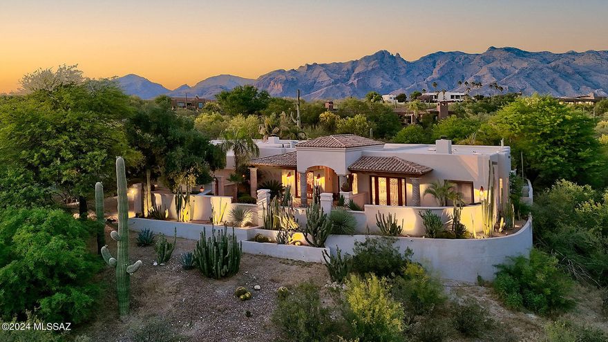 This stunning Spanish Colonial masterpiece by Nelson Builders is nestled in prestigious, guard-gated Hacienda Del Sol Estates in the Catalina Foothills. Located on a 1.3-acre interior lot away from traffic noise, this 4 bedroom+office+media room (that could be a 5th bedroom) home features quality construction and ''Old World'' charm throughout. Highlights include hand-built, one-of-a kind, exterior wrought-iron and interior antique doors & pillars. Additional features include custom cabinetry handmade in Mexico, faux painting, crown molding, Fortuny and Scudo Saraceno Glass Pendant light fixtures, custom lighted bookshelves, and hand carved cupboards - historic finishes not seen in today's contemporary style homes. The gourmet island kitchen offers granite counters, copper cabinet doors and designer appliances. The spacious family room, open to the kitchen, offers a dramatic fireplace with a custom mantel. The primary suite features a 2-way fireplace, a sitting room, and a luxurious primary bathroom with a spa tub, a hand-painted ceiling, an antique vanity with dual sinks & a large walk-in closet. The media room has a 109" projection TV with speaker system and a full bathroom. The office, with separate entrance, has built-ins including 2 computer desks. The 3-car garage offers a storage room and built-ins. Enjoy the beautiful grounds featuring a covered front & back porch, fountains, a sparkling pool/spa/waterfall, and an outdoor cooking area.