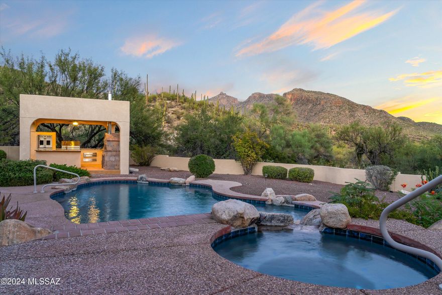 Nestled in the coveted Foothills/Sabino Canyon Corridor, sits this extraordinary 5BD, 4BA residence in the exclusive Sabino Ridge gated community. Set on a sprawling 1.04 acre lot with views of the Coronado National Forest, this stunning home offers 3,729 square feet of luxurious living space with an oversized 3-car garage. Designed by renowned builder Andy Arena, the home blends elegant design with thoughtful functionality.

Inside this stunning property you will be greeted by a spacious floor plan featuring a large family room with a cozy fireplace, a formal living room, and a double-door office/den. The home boasts 18-inch Travertine tile flooring, soaring 15-foot cathedral ceilings, and Andersen windows throughout allowing ample natural light and offering breathtaking panoramic mountain views that greet you from every angle. The expansive primary suite is a true retreat, complete with a fireplace, jetted tub, walk in shower and optimal storage. Generous walk-in closets in all five bedrooms with one bedroom having a private bath, making it an ideal guest suite. Designed for seamless indoor-outdoor living, French doors open to the resort style patio and backyard. From the massive, redone PebbleTec pool and spa to the gourmet outdoor kitchen this home is perfect for entertaining. The gourmet outdoor kitchen is a chef's dream, with high-end Viking appliances, a 6-burner gas range, double ovens, a huge bbq grill, a warming drawer, two cold storage drawers, an ice maker, three storage drawers, a wood-burning pizza oven, gorgeous granite countertops, a copper sink with disposal, and a misting system to enhance the space for year-round entertaining.

The low-maintenance landscaping includes desert foliage and fruit trees, completing this tranquil oasis. STUNNING MOUNTAIN VIEWS from the backyard. Don't miss this rare opportunity to own a one-of-a-kind property in one of Tucson's most private and sought-after locations. Recently painted exterior, brand new HVAC. Schedule a private showing today to experience this exceptional home in person.