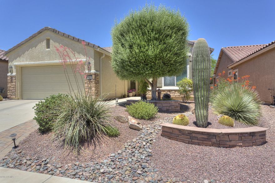 Rare find in 55+ Sonora Del Webb! Unique 1663 sq.ft. Picacho plan has not been available in 2 years. Stunning 3BR 2BA (opt. Den) home w/many hidden surprises. Kitchen opens to great room and breakfast area for casual living/dining. Formal dining easily accommodates 8, ideal for dinner parties and holiday gatherings. Kitchen w/Corian counters, gas range, pull-outs in lower cabinets, breakfast bar. Spacious master w/bay window; MBA has dual vanity exec height counters, walk-in closet, large linen closet. Laundry w/storage, newer W/D. Backyard water feature completes a peaceful outdoor setting. 2.5 car tandem garage offers separate parking for golf cart, workbench or storage. Pull down ladder in laundry leads to custom storage room in the attic, similar access in garage to more hidden storage