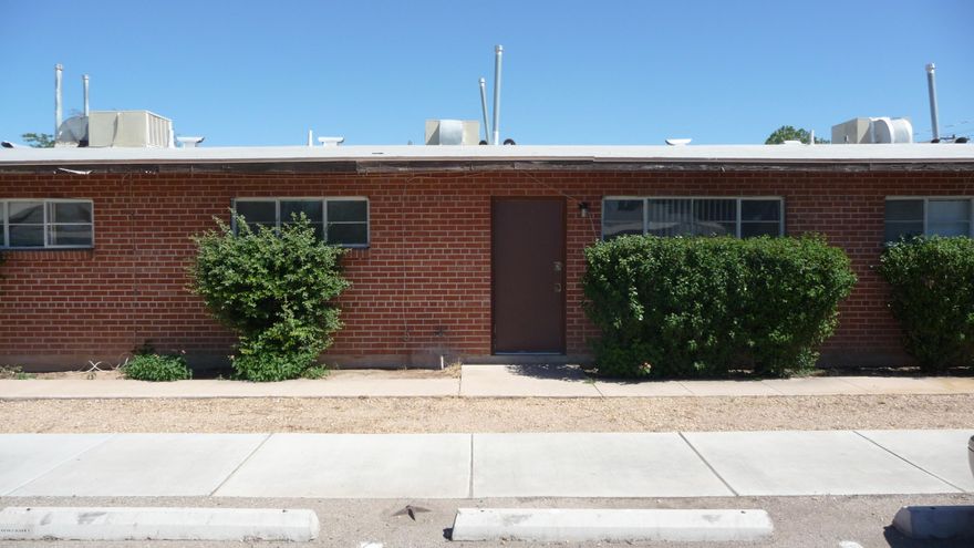Spacious unit of triplex with off street parking and fenced yard! Wire cut brick construction with open and cheery floor plan! Ceramic tile throughout. Gas heat and H/W, evap cooled for efficiency! Appealing, convenient location at an affordable price! Close to bus lines, schools and shopping, and just 3 miles from U of A!