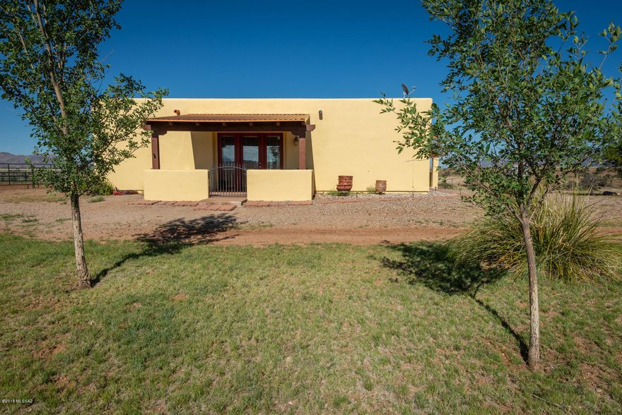 Big sky hilltop charming home with TOP OF THE WORLD panoramic views! Highly desirable location with end of road privacy. Nicely landscaped walled courtyard with views of the Mustangs, Whetstones and Huachuca Mtns. To the south this property overlooks a private ranch that leads to national forest nearby. (poss. ride-out on ranch with permission) Amazing horse facilities! Very spacious great room and kitchen with high ceilings. Beautiful natural stone adds rustic touch surrounding Jotul cast iron gas stove in great room. Extensive Arizona Room runs full length of home. Great for entertaining your guests!  Handsome rough cut wood beams accent doorways, Saltillo Tile flooring throughout, custom tile countertops, in the heart of Elgin Wine Country and nearby Parker Canyon Lake!  A must see home