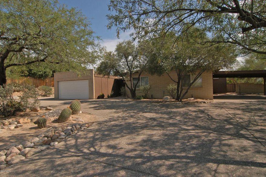This classic Tucson home on a private cul-de-sac lot awaits you! Features bright kitchen, double pane windows, stained glass entryway, brand new water heater and carpet (August 2015), tasteful neutral tile, ceiling fans, skylights and security door. Plenty of storage. BONUS master closet is large enough to be a home office and has a separate entrance. The backyard is an entertainer's dream. Large covered brick patio, hot tub, BBQ pit, even a polar aligned astronomy pier for star gazing! Room for all of your toys and hobbies with a 2 car garage that has storage rooms and a workbench, PLUS a 2 car carport. This home has been lovingly maintained and is move in ready. Hurry home!