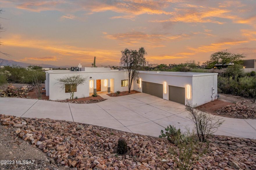 Seller will accept or counter offers between $799,000 and $850,000. Experience luxury living at the base of Tucson mountains! This home is located 5 minutes away from I-10 and 1 mile from Sweetwater Preserve Trails. This fully remodeled 5-bed, 3-bath home offers breathtaking views, ultimate privacy, and entertainment options galore. Host gatherings in the outdoor kitchen, by the fireplace, or around the pool. The gourmet kitchen with a wine bar, custom cabinet lighting, and ample counter space is a chef's dream. Unwind in the oversized Primary Suite with Catalina mountain views or in the tub of the spacious shower. Upgrades include new AC, plumbing, hot water heater, windows, stucco paint, concrete floors, and roof recoating. Smart home features abound. Your dream home awaits! Owner/Agent