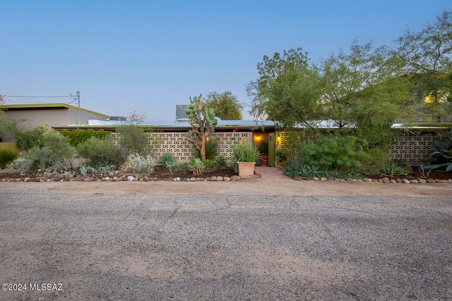 380 S Sentinel Peak Rd is truly a unique property in the highly sought-after Panorama Estates, lovingly crafted over decades by two extraordinary artists. Every detail of this 3 bedroom 2 bath  home reflects their creativity and care, blending artistic charm with the natural beauty of the desert.

The property boasts a lush desert botanical garden surrounding a serene winding Pebble Tec pool, offering an oasis-like retreat. A dedicated greenhouse enhances the outdoor living experience, perfect for cultivating plants year-round. Inside, the home showcases  a renovated kitchen with quartz counters,  stainless appliances and  beamed ceiling. The Saltillo tile, bamboo, and concrete floors, lending an earthy yet modern aesthetic to the living spaces. 

A standout feature is the large-- art studio, complete with soaring 12-ft ceilings, providing ample light and space for creative pursuits. Expansive windows throughout the home, connecting the indoors with the stunning surroundings. Stunning panoramic views of the Catalinas and Rincons and Tucson's downtown skyline below 

Situated on a generous 0.41-acre lot, the property not only offers privacy and tranquility but also room for potential additions or expansions. Whether you envision a guesthouse, a workshop, or expanded outdoor amenities, the possibilities are endless.

This home is more than a residenceit's a canvas for a life well-lived, where art, nature, and modern living harmoniously intersect.

Walk to hiking trails or jump over to the Mercado with the shopping, dining and entertainment or take the modern street car over to downtown Tucson, historic 4th ave or the U of A