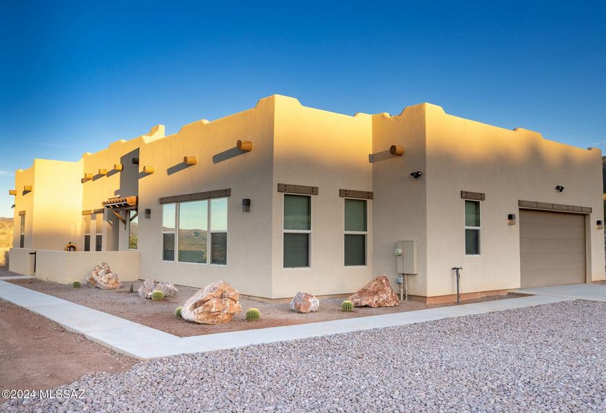 This custom hilltop home in the prestigious gated community of The Mesa offers stunning views from every room and combines privacy with proximity to Patagonia. It features 3 bedrooms, 2.5 bathrooms, and a versatile den perfect for various uses. The open floor plan includes a gas fireplace, expansive windows with upgraded blinds, and sleek tile flooring. The gourmet kitchen is equipped with a large island, pantry, soft-close cabinets, and stainless-steel appliances. Outside, the well-maintained landscaping enhances the home's curb appeal, providing a perfect backdrop for enjoying the breathtaking views. Don't miss the chance to make this exceptional property your own!
